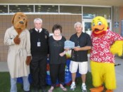 Building awareness: McGruff the Crime Fighting Dog and Tim Szymanski,
 Las Vegas Fire and Rescue Public Education & Information Officer, 
assist Lois Tarkanian, City Councilwoman, in presenting Joseph Vassallo,
 president of Paragon Pools, and Duckie, the Float Like A Duck mascot, 
with the 2014 National Drowning Prevention Alliance Community Lifesaver 
Award. The presentation was made on behalf of the NDPA during Vassallo’s
 annual water safety event on May 24 at the YMCA in Las Vegas.
