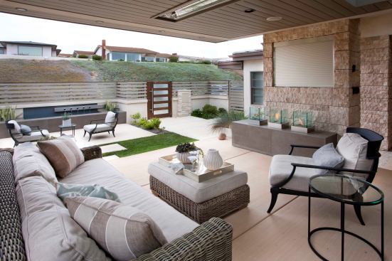 More often than not, TVs are found in the backyard. But with this home's location off the coast of San Diego, glares from the sun made it more applicable to an area facing north, which in this case, was the front yard. When not in use, a retractable cover hides the TV from sight.&nbsp;Above, built-in heating provides warmth during the cool morning and evening breeze.