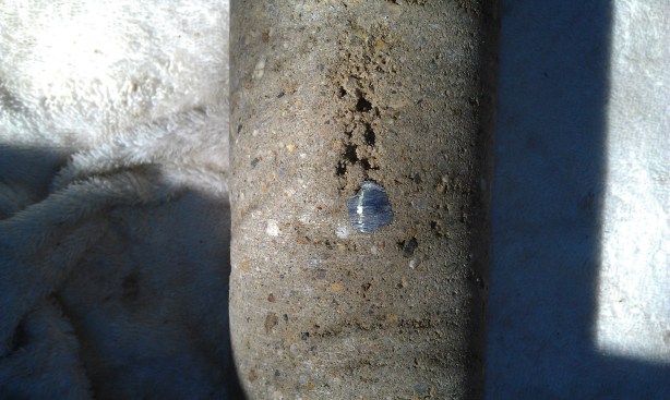 These photos show shadowing, in which shotcrete fails to properly 
compact behind the rebar. Here the concrete is not monolithic in the 
space behind the steel.